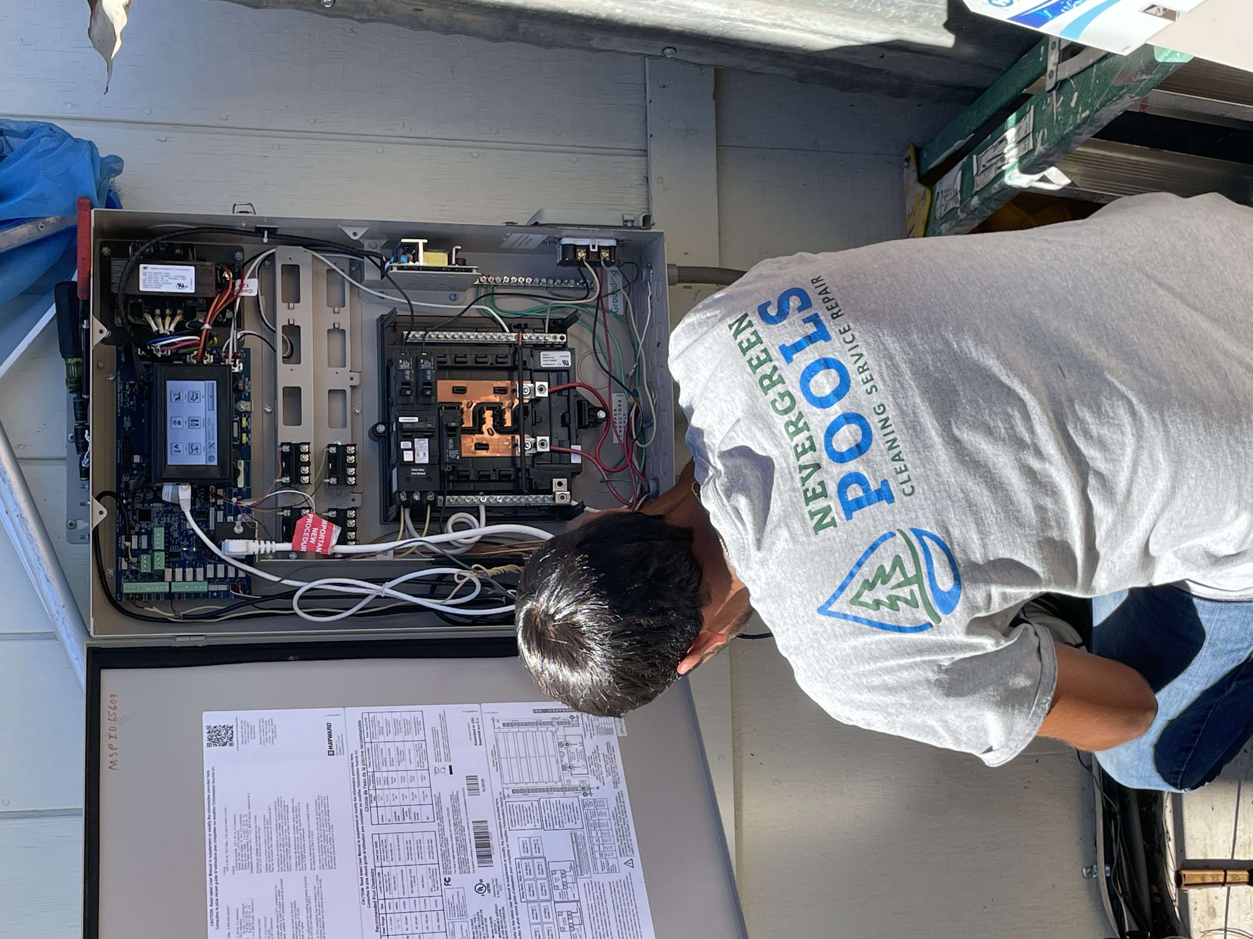 Nevergreen tech inspecting pool equipment