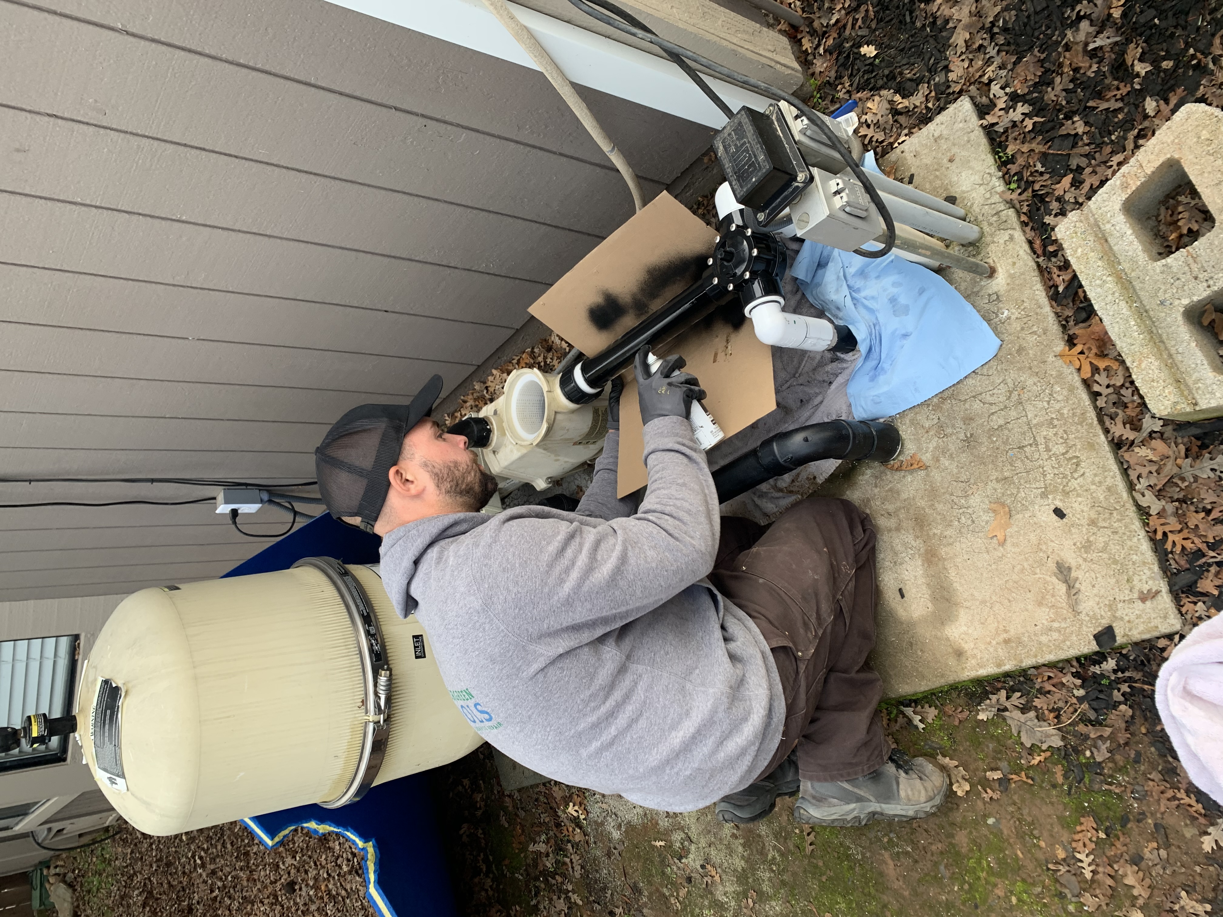 Nevergreen technician brushing a clean residential pool